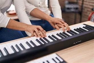 piano teacher and student
sitting at a piano